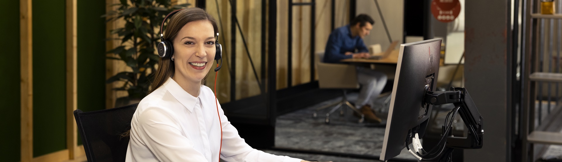 a woman with a headset behind a computer